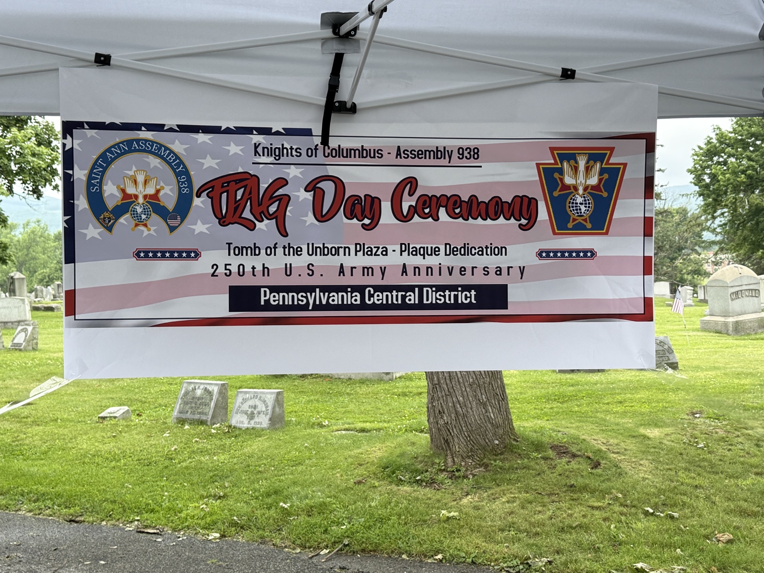 Flag Day Ceremony banner announcing the Tomb of the Unborn Plaza plaque dedication and the 250th U.S. Army anniversary.